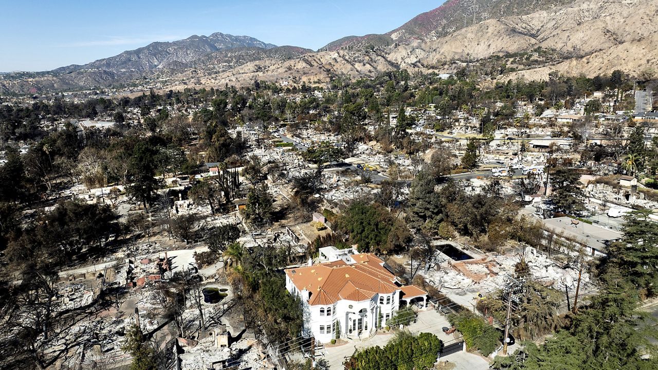 Aerial view of Altadena neighborhoods showing burned lots beside surviving homes after the Eaton Fire